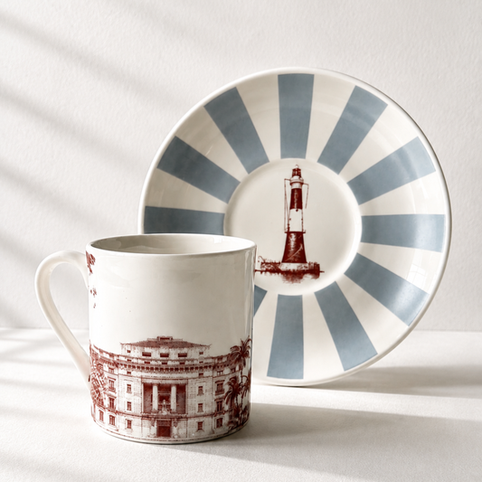 Portside cup with Ballard Estate building illustration beside a striped saucer showing Prongs Lighthouse